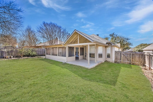 rear view of property featuring a patio area, a fenced backyard, a lawn, and a chimney