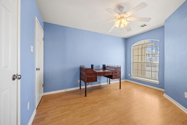 office with visible vents, baseboards, a ceiling fan, and wood finished floors