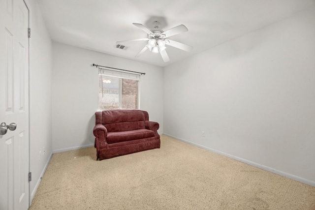 sitting room featuring carpet, baseboards, visible vents, and ceiling fan