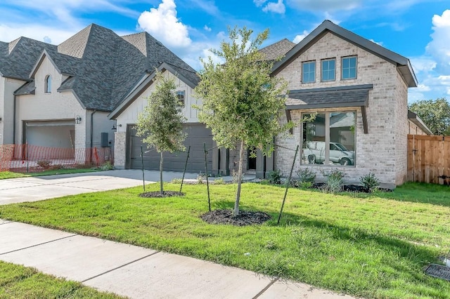 view of front of house with fence, concrete driveway, a front yard, a garage, and brick siding