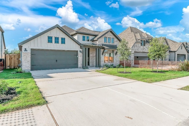 view of front facade with board and batten siding, concrete driveway, a front lawn, and fence