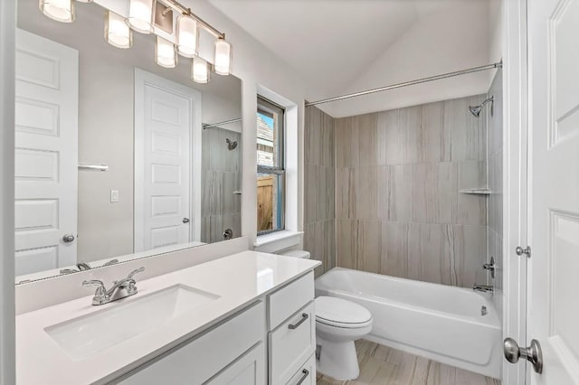 full bathroom with vanity, vaulted ceiling, toilet, and shower / bathtub combination