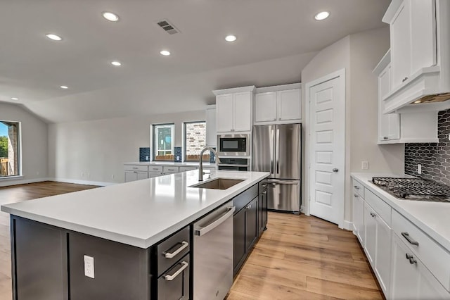 kitchen featuring a healthy amount of sunlight, visible vents, a sink, light countertops, and appliances with stainless steel finishes