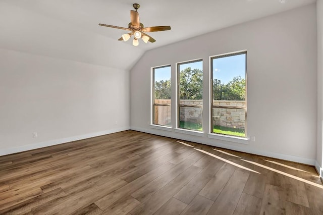 bonus room with vaulted ceiling, wood finished floors, baseboards, and ceiling fan