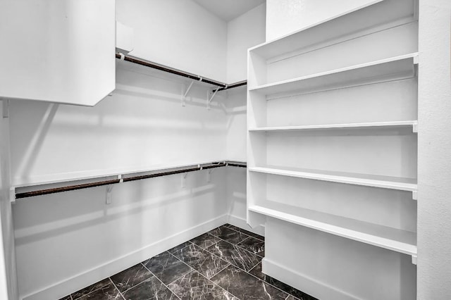 spacious closet with marble finish floor