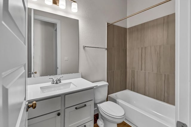 full bath featuring toilet, vanity, bathing tub / shower combination, and a textured wall