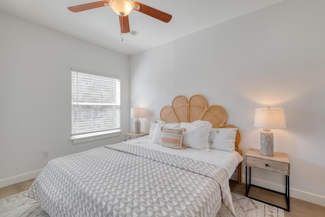 bedroom with a ceiling fan and baseboards