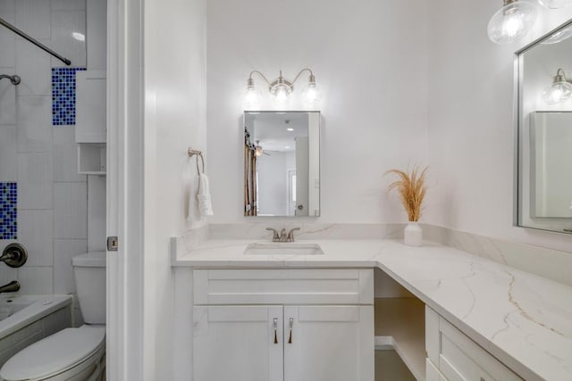 full bathroom with toilet, vanity, and  shower combination