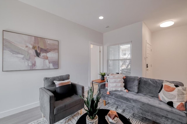 living room featuring recessed lighting, baseboards, and wood finished floors