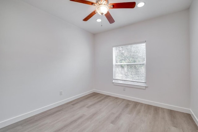 spare room featuring recessed lighting, light wood-style flooring, baseboards, and ceiling fan