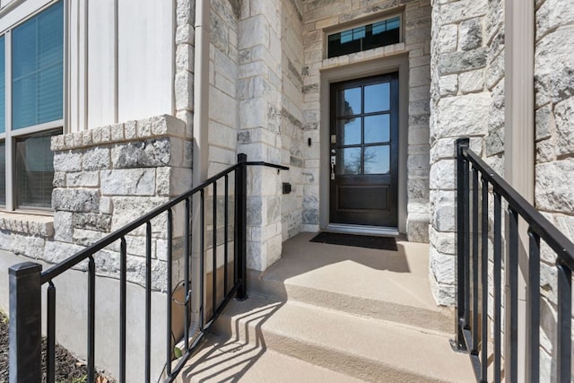 doorway to property with stone siding