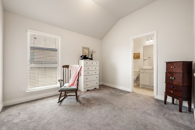 living area with baseboards, lofted ceiling, and carpet floors