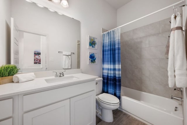 bathroom with vanity, toilet, wood finished floors, and shower / tub combo with curtain