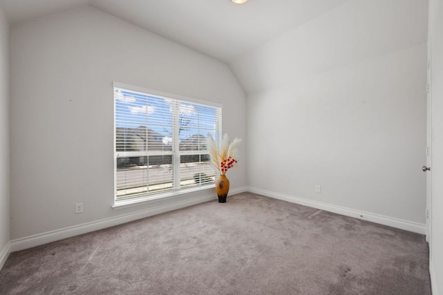 empty room with baseboards, carpet, and lofted ceiling