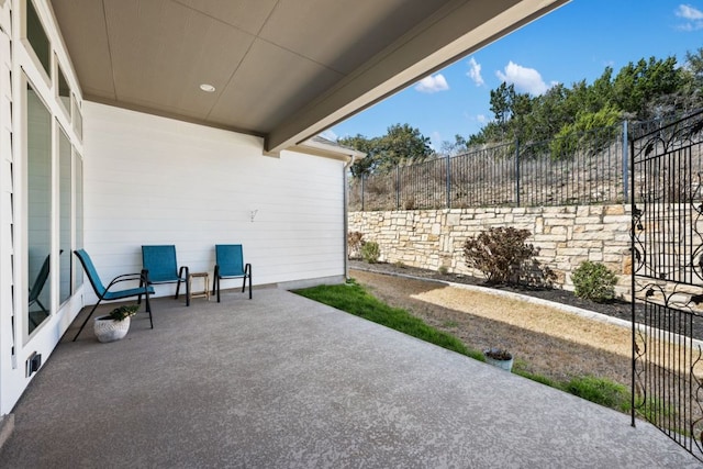 view of patio featuring fence