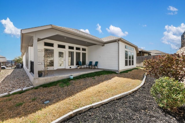 rear view of house with a patio and fence