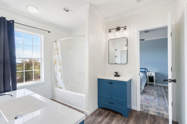 ensuite bathroom featuring visible vents, shower / bath combo with shower curtain, wood finished floors, crown molding, and vanity