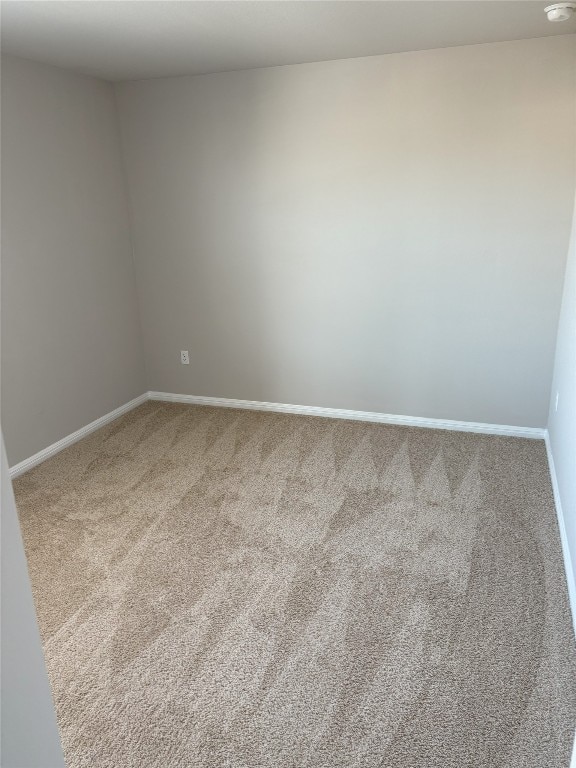 empty room with baseboards and carpet floors