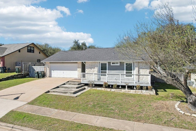 ranch-style house with a front lawn, concrete driveway, and fence