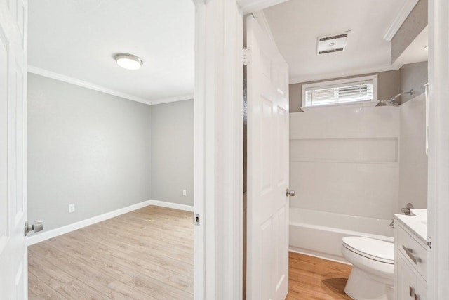 bathroom with vanity, toilet, crown molding, and wood finished floors