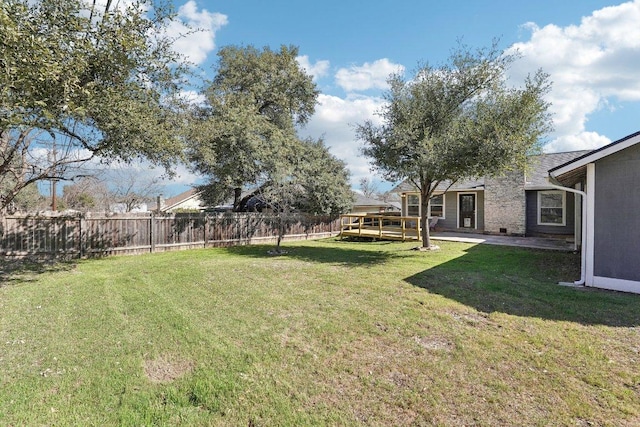 view of yard featuring a deck and fence