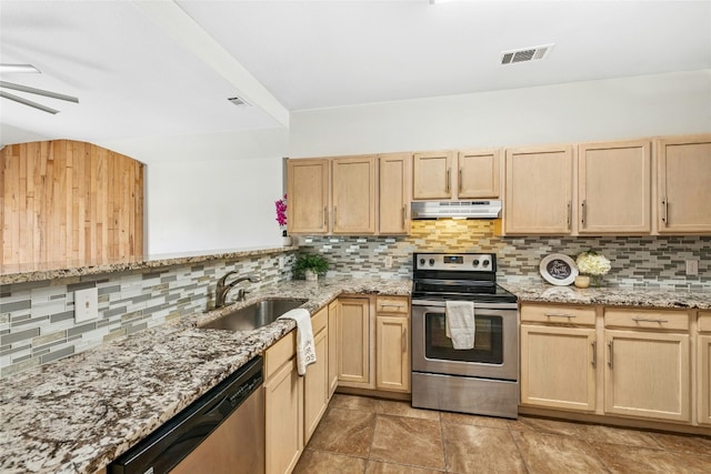 kitchen featuring under cabinet range hood, light brown cabinets, appliances with stainless steel finishes, and a sink