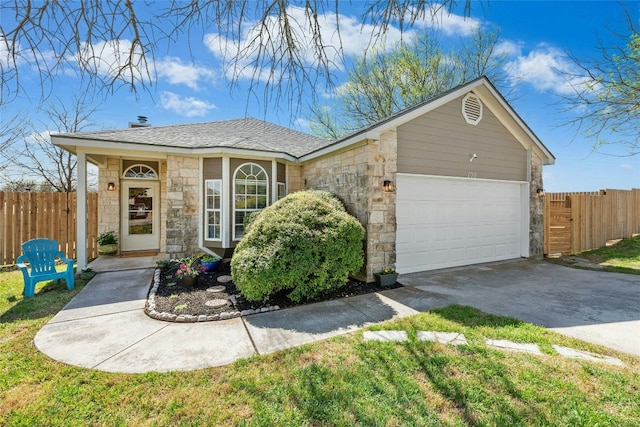 ranch-style house with concrete driveway, fence, stone siding, and a shingled roof