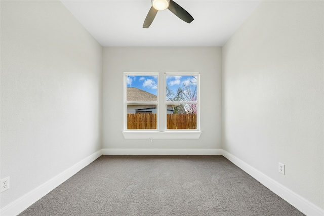 unfurnished room with a ceiling fan, baseboards, and carpet floors