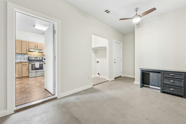 interior space with baseboards, visible vents, concrete floors, and ceiling fan