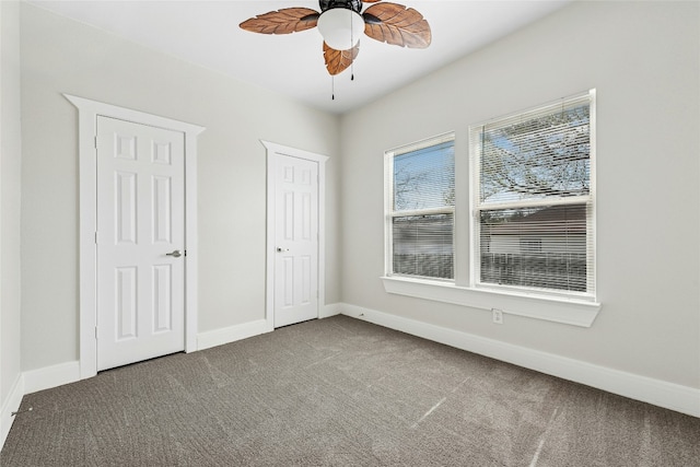 unfurnished bedroom with carpet flooring, ceiling fan, and baseboards