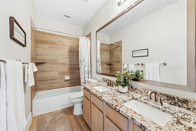 full bath featuring a sink, visible vents, toilet, and wood finished floors