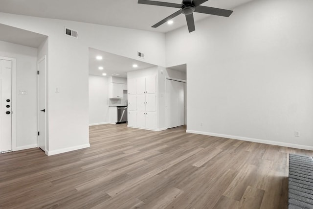 unfurnished living room with light wood-style flooring, baseboards, visible vents, and ceiling fan