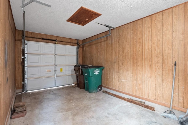 garage with baseboards and wooden walls