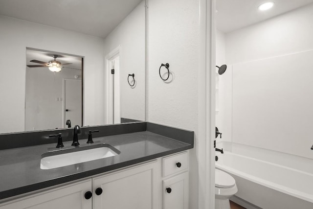 full bathroom featuring shower / bathing tub combination, toilet, ceiling fan, and vanity