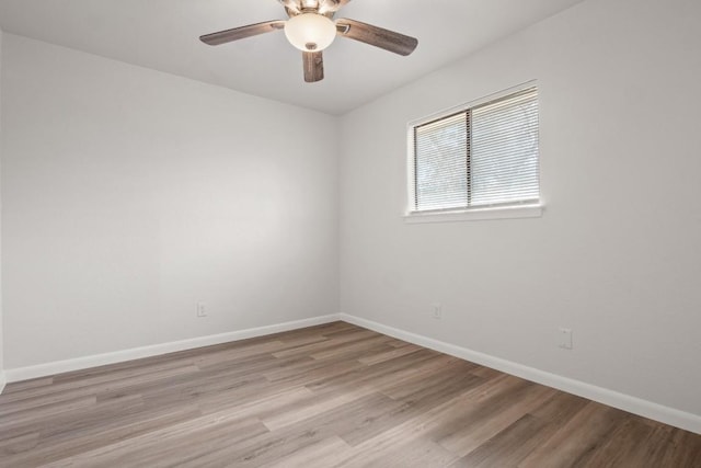 unfurnished room with light wood finished floors, ceiling fan, and baseboards