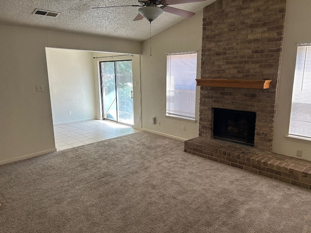 unfurnished living room with visible vents, a textured ceiling, carpet flooring, ceiling fan, and vaulted ceiling