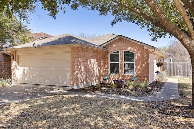 view of front facade featuring brick siding, an attached garage, concrete driveway, and fence