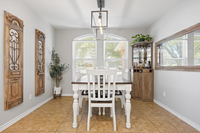 dining space with light tile patterned floors and baseboards