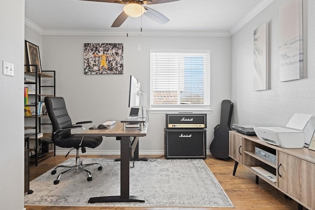 office featuring baseboards, crown molding, ceiling fan, and wood finished floors