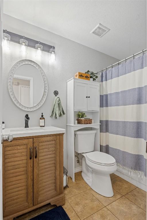 full bath with visible vents, toilet, a shower with curtain, tile patterned floors, and vanity