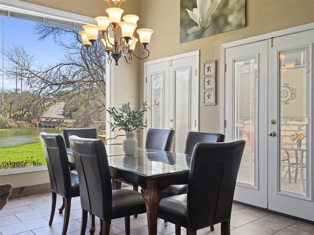 dining space with french doors, plenty of natural light, and a chandelier