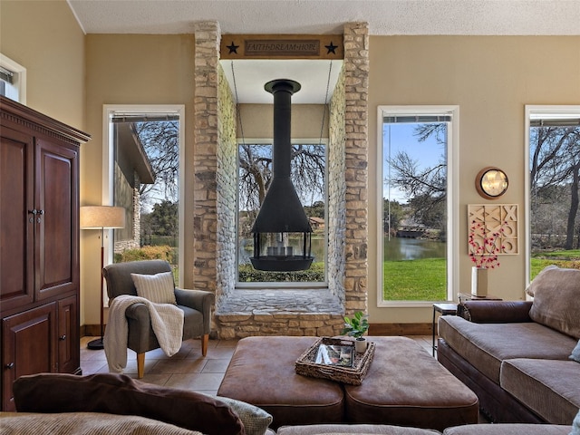 living room featuring light tile patterned floors, a wealth of natural light, and a textured ceiling