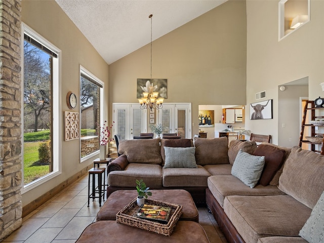 living area with light tile patterned floors, visible vents, a notable chandelier, and a healthy amount of sunlight