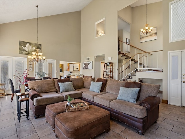 living room featuring stairway, lofted ceiling, and a notable chandelier