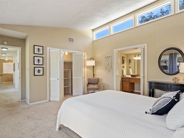 carpeted bedroom featuring baseboards, visible vents, high vaulted ceiling, a closet, and a textured ceiling