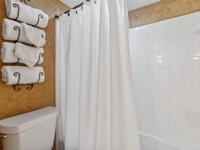 bathroom with toilet and shower / bath combo with shower curtain