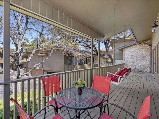 wooden terrace with outdoor dining space