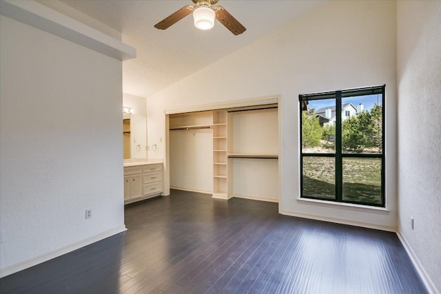 405 S Cowal Dr, Spicewood, TX 78669 - unfurnished bedroom featuring high vaulted ceiling, a closet, dark wood finished floors, baseboards, and ceiling fan