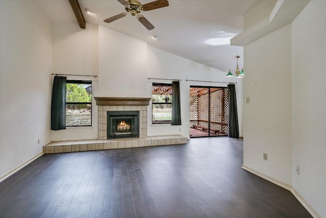 405 S Cowal Dr, Spicewood, TX 78669 - unfurnished living room featuring dark wood-style flooring, baseboards, ceiling fan, high vaulted ceiling, and beam ceiling