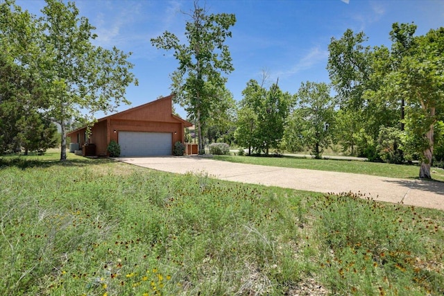 405 S Cowal Dr, Spicewood, TX 78669 - view of front facade with driveway, an attached garage, a front lawn, and central air condition unit